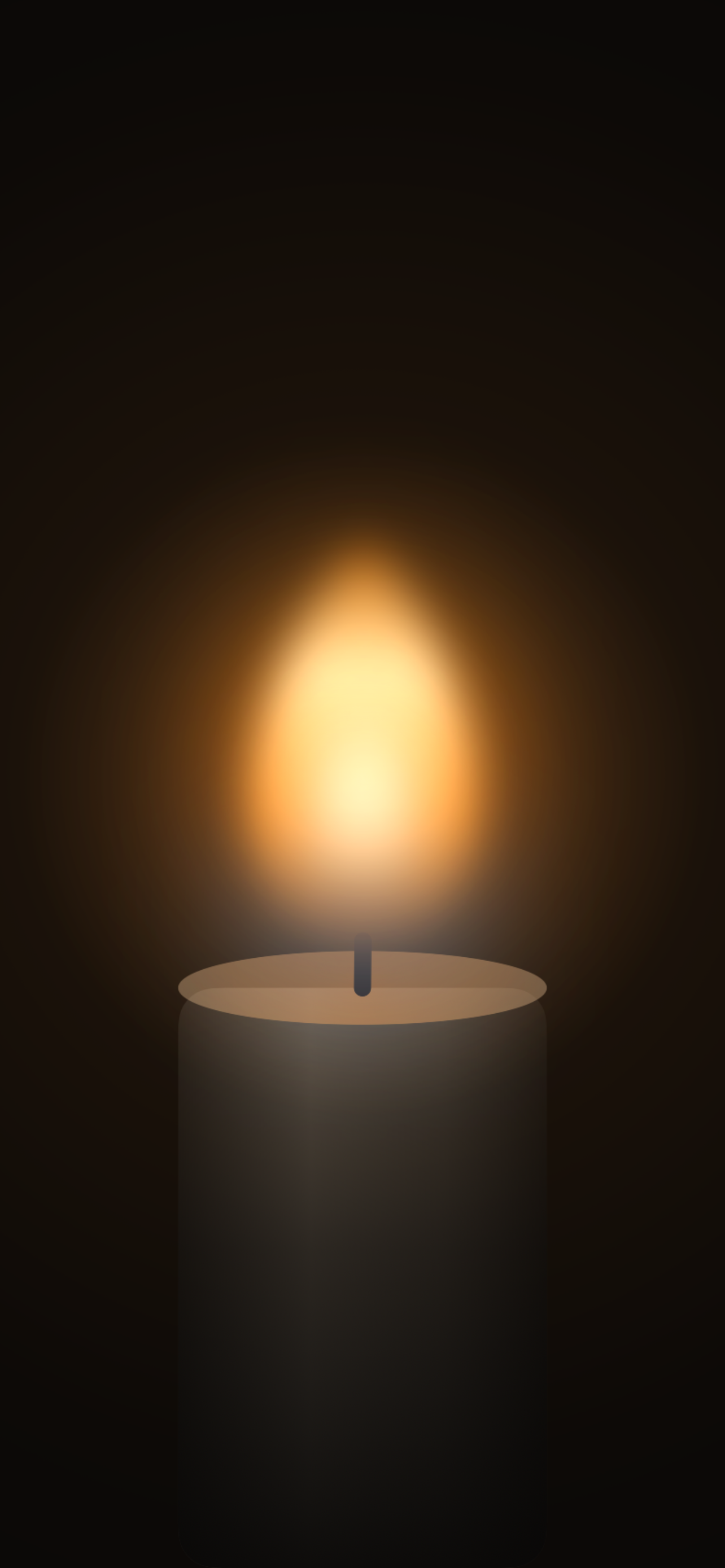A lit candle filling the screen, its flame glowing against black